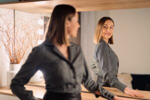 Self confident,Woman,Looking,At,Her,Reflection,Into,The,Mirror,Indoors.