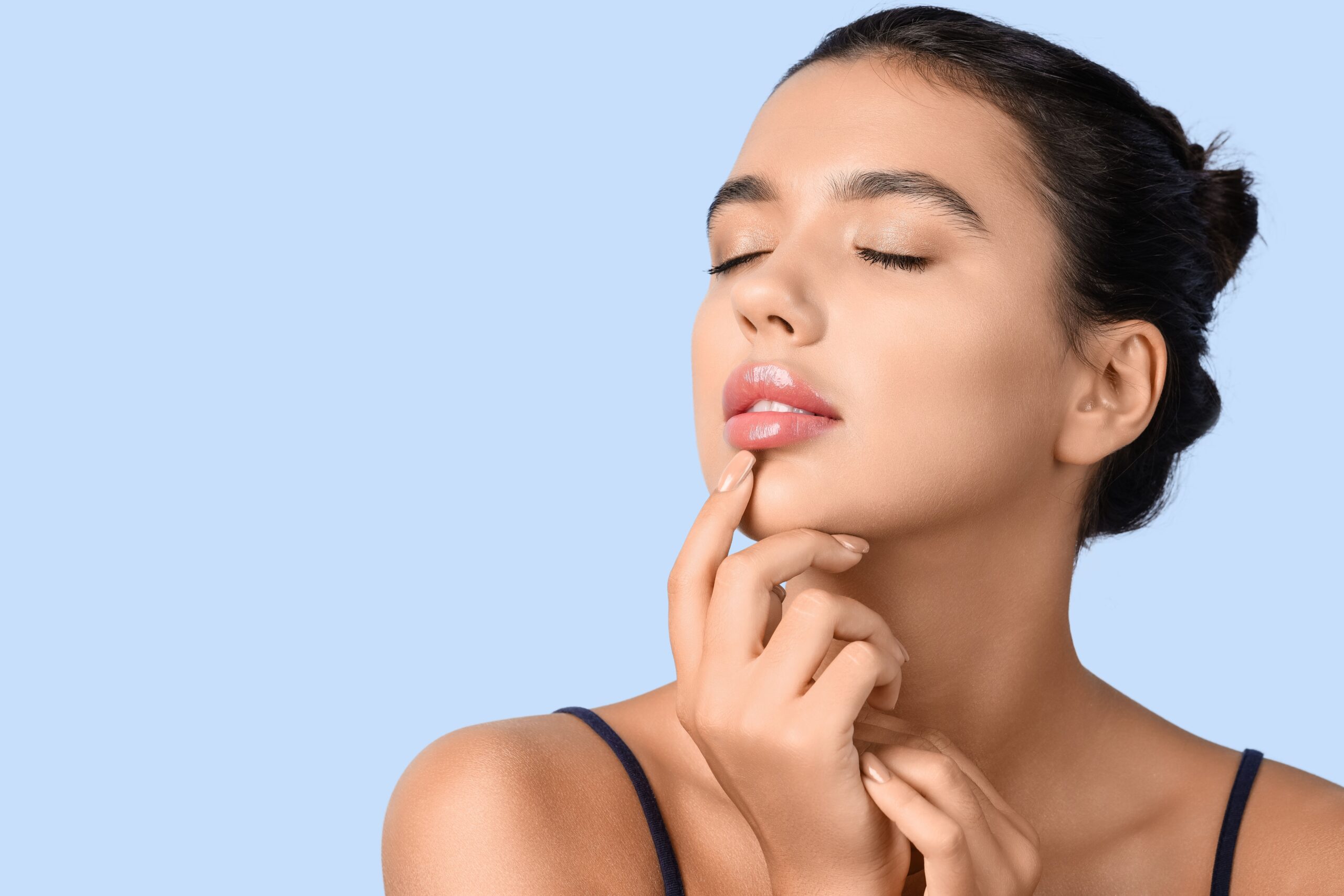 Young,Woman,With,Beautiful,Lips,On,Blue,Background,,Closeup