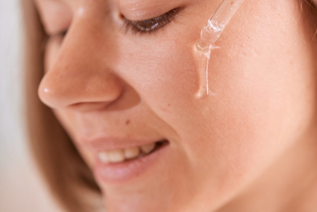 Young,Girl,Applying,Vitamins,To,Her,Face,At,Home,,Skin